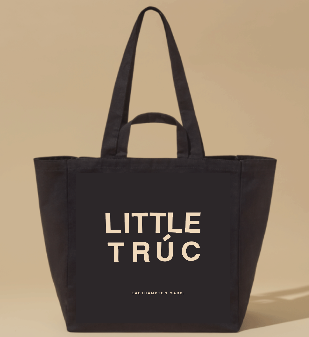 black tote bag with little truc, easthampton mass. written on it in cream lettering